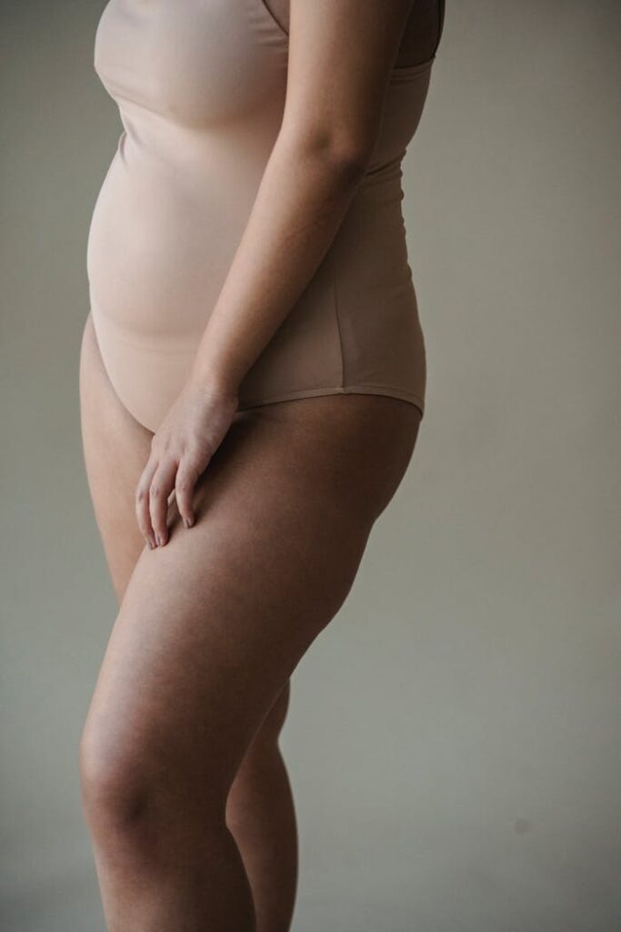 Elegant portrait highlighting body positivity and confidence in neutral tone underwear.